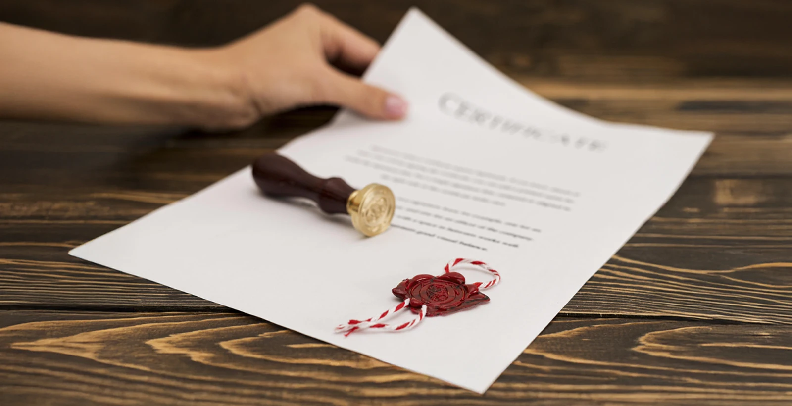 Official certificate with red wax seal and stamp on a wooden desk, representing SOC 2 certification and compliance requirements in the UAE