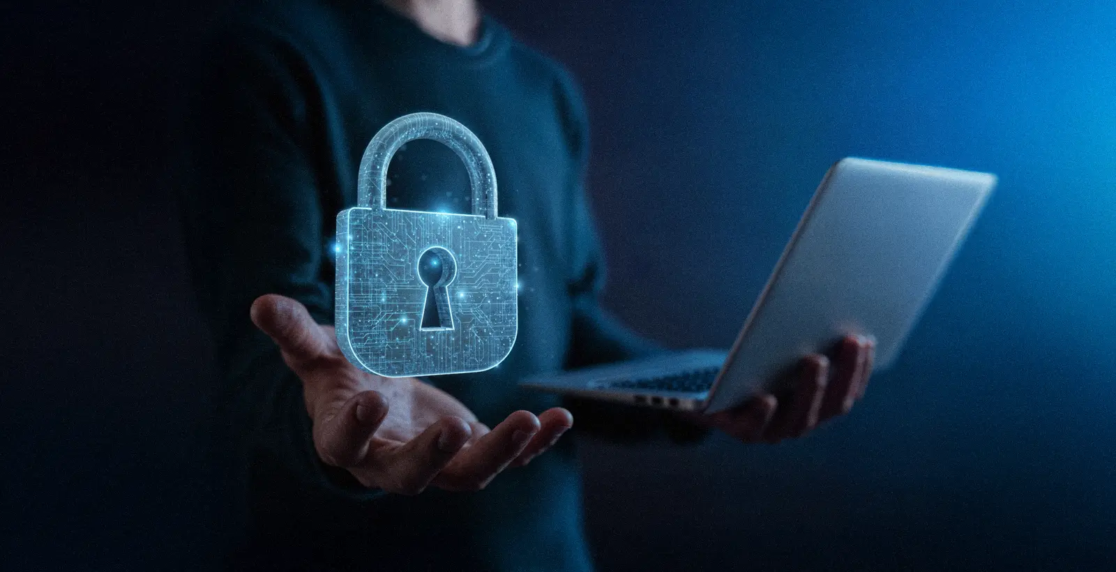 Person holding a laptop with a glowing digital padlock hologram, symbolizing data privacy, compliance, and protection