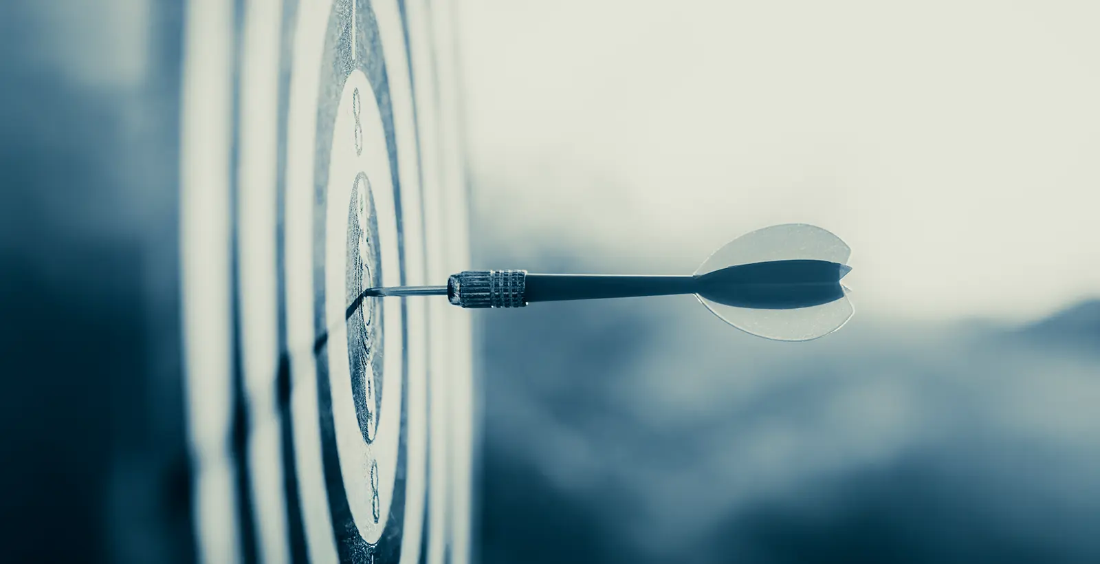 Dart striking a bullseye target representing HITRUST certification as a strategic tool for winning enterprise deals faster and strengthening B2B security trust.