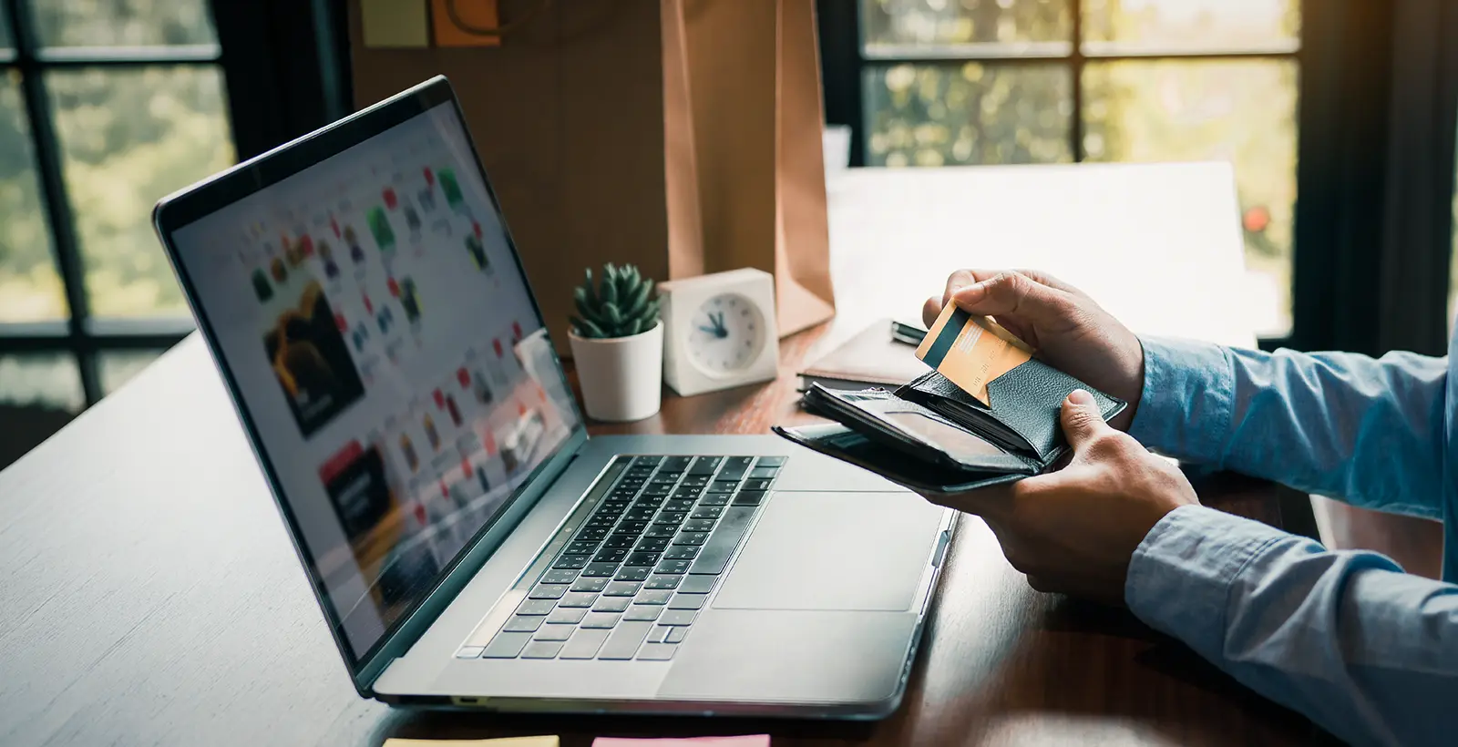 Person using a credit card and laptop for online payment, illustrating PCI DSS compliance, secure payment processing, and payment data security for small businesses.