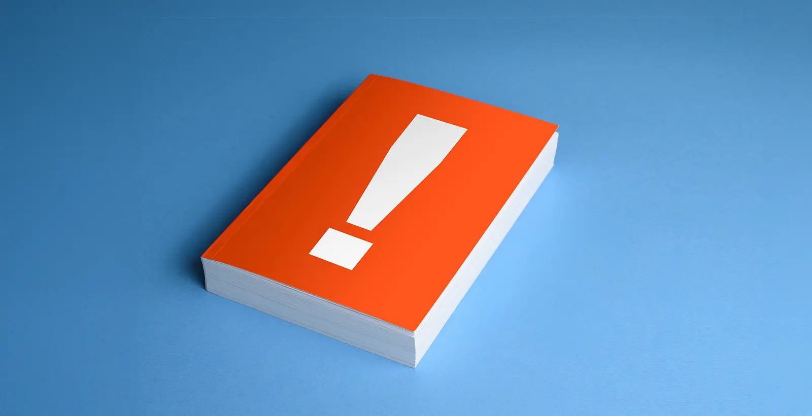 an orange coloured book with a large exclamation mark symbolising the Common Misconceptions About ISO 27001 Certification